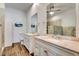 Elegant bathroom with double vanity sinks, granite countertops, wood floors, and walk-in shower at 217 22Nd Street Ne Ct, Bradenton, FL 34208