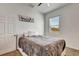 Bedroom with cozy bed, featuring a ceiling fan, plush bedding and natural light at 217 22Nd Street Ne Ct, Bradenton, FL 34208