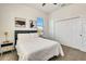 Cozy bedroom with neutral carpet, a modern bed, and a closet for storage at 217 22Nd Street Ne Ct, Bradenton, FL 34208
