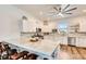 Bright kitchen featuring a marble countertop island, stainless steel appliances, and sleek white cabinets at 217 22Nd Street Ne Ct, Bradenton, FL 34208