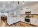 Bright kitchen with a stylish island, modern appliances, and an open layout leading to the dining area at 217 22Nd Street Ne Ct, Bradenton, FL 34208