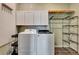 This laundry room features a modern washer and dryer with built in shelving at 217 22Nd Street Ne Ct, Bradenton, FL 34208