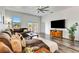 Spacious living room features wood floors, a ceiling fan, and a comfortable sectional sofa at 217 22Nd Street Ne Ct, Bradenton, FL 34208