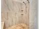 Elegant tiled walk-in shower with dual showerheads and built-in seating at 217 22Nd Street Ne Ct, Bradenton, FL 34208