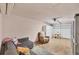 Cozy basement setup with a gray sofa, a lounge chair, and a table near the garage door at 217 High Point Dr # 217A, Englewood, FL 34223
