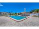 The community pool features a shaded pergola and is surrounded by brick pavers at 217 High Point Dr # 217A, Englewood, FL 34223