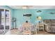 Cozy dining area with a floral tablecloth, adjacent to sliding doors and living space at 217 High Point Dr # 217A, Englewood, FL 34223