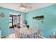 Inviting dining area featuring a sliding door to the porch, seating for four, and coastal decor at 217 High Point Dr # 217A, Englewood, FL 34223