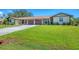 Well-maintained exterior with green lawn, double garage, and inviting curb appeal at 217 High Point Dr # 217A, Englewood, FL 34223