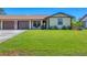 Well-maintained front yard with a lush green lawn and an attached garage for convenient parking at 217 High Point Dr # 217A, Englewood, FL 34223