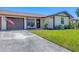 Charming front yard with a well-kept lawn and a driveway leading to an attached garage at 217 High Point Dr # 217A, Englewood, FL 34223