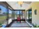 Screened lanai with tile flooring, outdoor furniture, ceiling fan, and a view of the backyard at 217 High Point Dr # 217A, Englewood, FL 34223