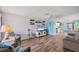 Open-concept living room leading to kitchen with coastal decor and modern furnishings at 217 High Point Dr # 217A, Englewood, FL 34223