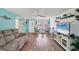 Cozy living room with wood floors, bright walls, and comfortable seating area at 217 High Point Dr # 217A, Englewood, FL 34223
