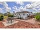 Backyard patio with seating, brick pathways, and lush landscaping for outdoor relaxation and entertainment at 2402 33Rd W St, Bradenton, FL 34205