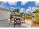 Outdoor patio with seating and well-maintained landscaping, perfect for relaxing and entertaining guests at 2402 33Rd W St, Bradenton, FL 34205