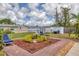 Spacious backyard featuring outdoor seating, lush landscaping, and storage sheds in a fenced yard at 2402 33Rd W St, Bradenton, FL 34205
