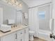Bright bathroom with white vanity, quartz countertop, updated fixtures, and shower-tub combination at 2402 33Rd W St, Bradenton, FL 34205
