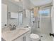Clean bathroom featuring glass shower door, marble countertop, updated fixtures, and tiled shower at 2402 33Rd W St, Bradenton, FL 34205
