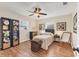 Bedroom with wood flooring, ceiling fan, natural light, and space for a cozy seating area at 2402 33Rd W St, Bradenton, FL 34205