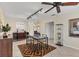 Bright dining area featuring tile flooring, track lighting, ceiling fan, and decorative geometric rug at 2402 33Rd W St, Bradenton, FL 34205