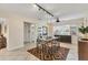 Bright dining area featuring tile flooring, track lighting, ceiling fan, and decorative geometric rug at 2402 33Rd W St, Bradenton, FL 34205