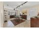 Bright dining area featuring tile flooring, track lighting, ceiling fan, and decorative geometric rug at 2402 33Rd W St, Bradenton, FL 34205