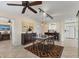 Dining area with tile flooring, geometric rug, ceiling fan, pendant lights, and view of the kitchen at 2402 33Rd W St, Bradenton, FL 34205