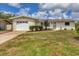 Single-story home with a well-kept lawn, attached garage, and tidy landscaping at 2402 33Rd W St, Bradenton, FL 34205