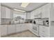 Modern kitchen with white cabinets, stainless steel appliances, and stylish countertops at 2402 33Rd W St, Bradenton, FL 34205