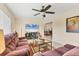 Bright living room showcasing tile floors, a ceiling fan, and a comfortable seating area at 2402 33Rd W St, Bradenton, FL 34205