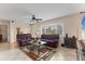 Bright living room showcasing tile floors, a ceiling fan, and comfortable sofas at 2402 33Rd W St, Bradenton, FL 34205