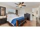 Bright main bedroom showcasing wood floors, ceiling fan, and views through the windows and doorway at 2402 33Rd W St, Bradenton, FL 34205