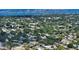 An aerial view shows the property surrounded by trees in a residential neighborhood near Sarasota Bay at 2516 Goldenrod St, Sarasota, FL 34239