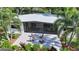 Overhead view of the screened in outdoor living space with open patio area surrounded by lush landscaping at 2516 Goldenrod St, Sarasota, FL 34239