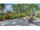 Cozy backyard patio with seating arrangement surrounded by lush landscaping and a wooden privacy fence at 2516 Goldenrod St, Sarasota, FL 34239