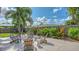 Inviting backyard patio with seating, tropical landscaping, and a privacy fence is perfect for outdoor relaxation at 2516 Goldenrod St, Sarasota, FL 34239