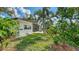 Beautifully landscaped backyard including the screened-in porch, open patio and the outdoor living area at 2516 Goldenrod St, Sarasota, FL 34239