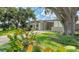 Stylish home showcasing modern architectural elements and mature trees providing shade and character at 2516 Goldenrod St, Sarasota, FL 34239