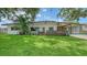 Charming single-story home with a well-manicured lawn and mature landscaping, offering inviting curb appeal at 2516 Goldenrod St, Sarasota, FL 34239