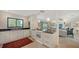 Open-concept kitchen with a breakfast bar seamlessly connected to the living room area at 2516 Goldenrod St, Sarasota, FL 34239