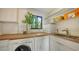 Modern laundry room with washer, dryer, sink, and storage shelves, creating a functional and organized space at 2516 Goldenrod St, Sarasota, FL 34239