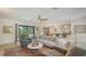 Open living area with comfortable seating, a ceiling fan, and seamless flow into the dining area at 2516 Goldenrod St, Sarasota, FL 34239