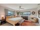 Relaxing main bedroom with large windows, ceiling fan, and decorative rug at 2516 Goldenrod St, Sarasota, FL 34239