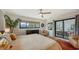 Bright main bedroom boasts a ceiling fan, dresser and access to outdoor patio at 2516 Goldenrod St, Sarasota, FL 34239
