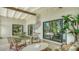 Stylish screened patio with seating, dining area, and decorative wall art at 2516 Goldenrod St, Sarasota, FL 34239
