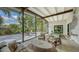 Stylish screened patio with comfortable seating areas and views of the landscaped backyard at 2516 Goldenrod St, Sarasota, FL 34239