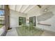 Dining area on a screened patio with views of the lush backyard and modern decor at 2516 Goldenrod St, Sarasota, FL 34239