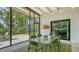 Screened-in patio area with an outdoor dining table and backyard views at 2516 Goldenrod St, Sarasota, FL 34239