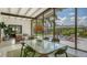 Screened patio with an outdoor dining area, views of the yard, and a stylish aesthetic at 2516 Goldenrod St, Sarasota, FL 34239